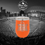 Orange stemless wine tumbler with laser engraved World Series Champions 2022 trophy design, ballpark backdrop