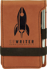 Rawhide leatherette mini notepad with silver pen, laser engraved with rocket ship writer logo