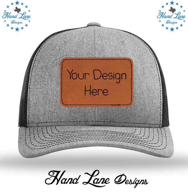 Heather gray and black Richardson 112 trucker hat with rawhide leatherette patch reading Your Design Here