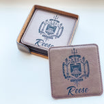 Square leatherette coasters engraved with US Naval Academy crest and name Reese, one propped against the holder set