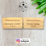Two personalized wood name tags engraved with realtor names and company lettering