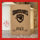 Cork journal engraved with Warriors mascot shield logo and the name Gracie, personalized team gift