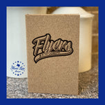 Engraved cork journal featuring St. Joseph Flyers baseball-script team logo, standing upright