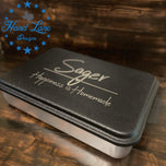 Black lid on aluminum 13x9 cake pan custom engraved with Sager family name and Happiness is Homemade script