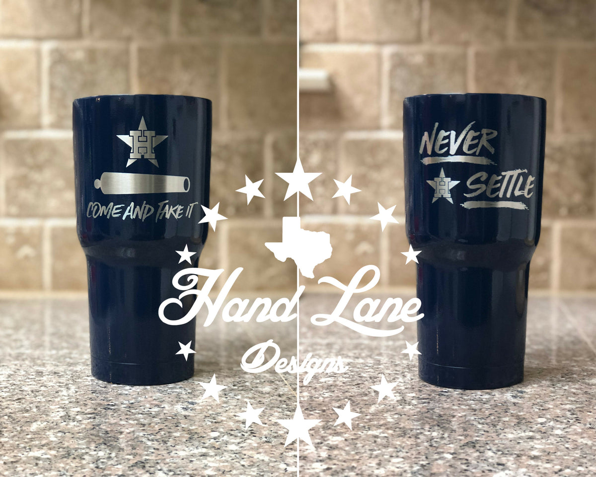 Navy powder coated 30oz tumbler shown both sides with Houston Astros Come and Take It cannon and Never Settle engravings