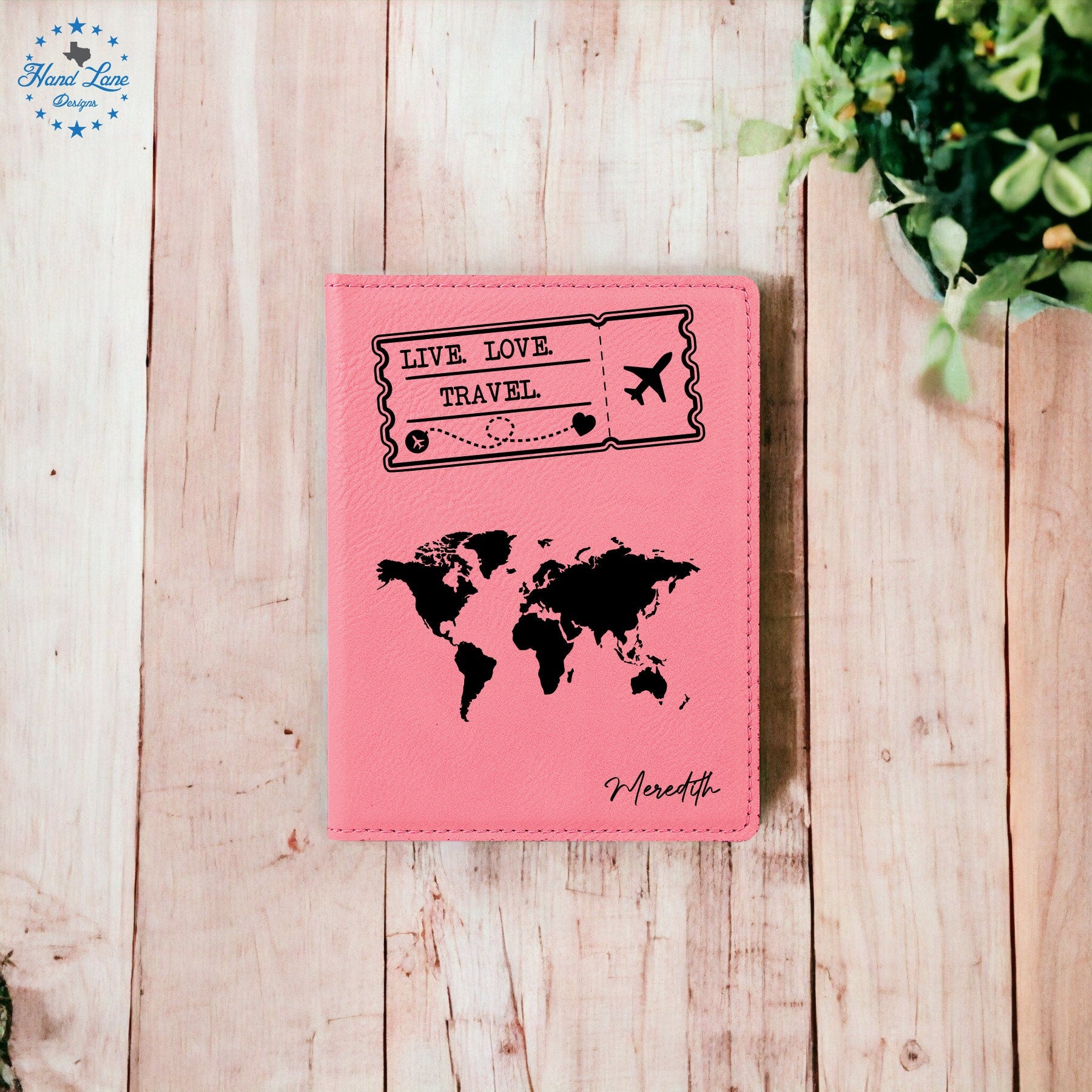 a pink passport case with a world map on it