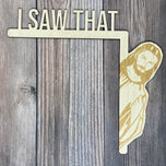 Natural wood I Saw That Jesus door hanger with engraved peeking Jesus over a door frame corner