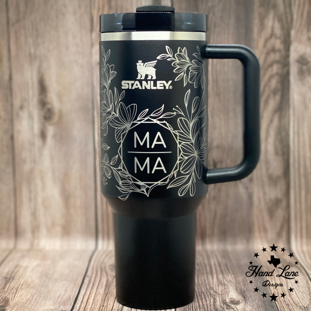 Black Stanley 40oz tumbler with handle, full wrap floral engraving and MAMA design on the front