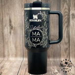 Black Stanley 40oz tumbler with handle, full wrap floral engraving and MAMA design on the front