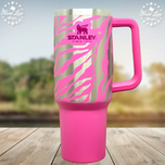 Hot pink 40oz Stanley Quencher tumbler with laser engraved zebra stripes revealing stainless steel