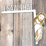White I Saw That door hanger with laser engraved peeking Jesus on wood, shown on dark planks